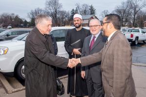 Cardinal Cupich is greeted by Sheikh Hasan Mostafa Aly, Dr. Muhammad Hamedeh, Council of Islamic Organizations of Greater Chicago Chairman, and Zulfie Khan, CIOGC Board Director, upon arriving for the CIOGC Muslim-Catholic Interfaith Iftar Dinner on March 4, 2025, at the Muslim Community Center in Morton Grove. (Deacon Randy Belice/Chicago Catholic)
