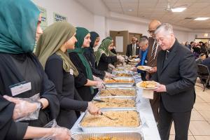 Cardinal Cupich receives food from volunteers. (Deacon Randy Belice/Chicago Catholic)