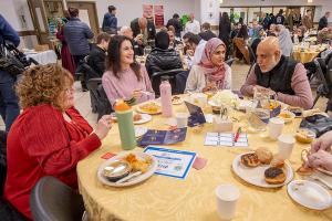 Kareem Irfan and his wife Rana (right) share conversation with Village of Morton Grove Trustees Connie Travis (left) and Janine Witko. (Deacon Randy Belice/Chicago Catholic)