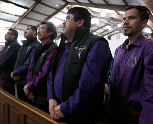 Javier Abrego, Doroteo Cisneros, Martin Carillo, Martin Abrejo and Mauro Cisneros, members of the Senor Del Amparo ministry, pray during Mass. (Karen Callaway/Chicago Catholic)