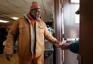 Fred Brisco assists clients at the door. (Karen Callaway/Chicago Catholic)