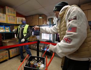 Volunteer Robert Maggitt assists Client Jerome Braswell with his choice of cereals. (Karen Callaway/Chicago Catholic)