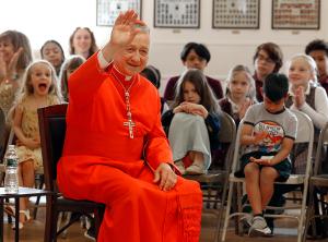 Cardinal Cupich waves to the students as he is introduced. (Karen Callaway/Chicago Catholic)