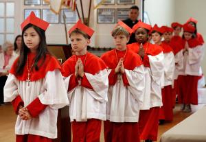 Student cardinals process to the podium to act out swearing an oath before the conclave. (Karen Callaway/Chicago Catholic)
