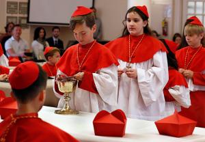 Student cardinal Auggie Wilk places his vote into the chalice. (Karen Callaway/Chicago Catholic)