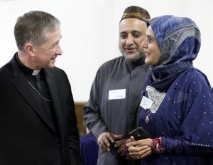 Archbishop Cupich visits with Kareem and Rana Irfan during the19th-annual Catholic-Muslim Iftar dinner at the Zakat Foundation of America in Bridgeview on June 27. The iftar is the evening meal when Muslims end their daily Ramadan fast at sunset. (Karen Callaway/Catholic New World)