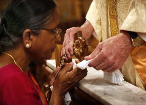 Asuntha Mary venerates a relic of St. Mother Teresa following Mass on Sept 4. (Karen Callaway/Catholic New World)