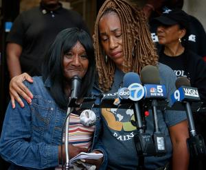 Pam Bosley, co-founder of Purpose Over Pain, comforts Melissa Taylor, whose 14-year-old son Tyrese Taylor was shot and killed in North Lawndale, before a peace walk at St. Sabina Church in Auburn Gresham on June 25, 2021. (Karen Callaway/Chicago Catholic)