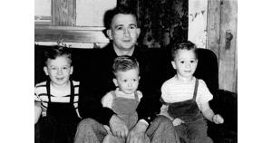 A young Blase Cupich sits on his father’s lap between his older brothers Bob (left) and Rich (right). (Photos provided by Rich Cupich)