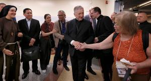 Cardinal Cupich greets people at a reception following Mass in the hall next to the cathedral. (Karen Callaway/Chicago Catholic)