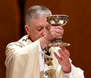 Cardinal Cupich holds up the Blood of Christ during the Eucharistic Prayer at Mass. (Karen Callaway/Chicago Catholic)