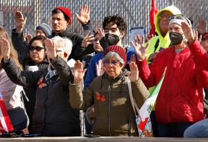 Participants pray over the delegation who will attempt to distribute Communion to detainees. (Karen Callaway/Chicago Catholic)