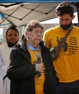 Mercy Sister JoAnn Persch, a longtime supporter for immigrant rights, informs the gathering that they were denied entrance to distribute Communion to detainees. (Karen Callaway/Chicago Catholic)