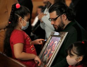 Un padre y su hija captados en la misa para celebrar al Señor de Esquipulas.
