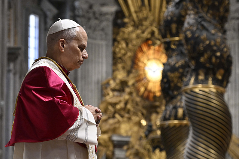 Pope Leo XIV prays in St. Peter's Basilica at the Vatican April 11, 2026, during a prayer vigil and the recitation of the rosary for peace. (CNS photo/Vatican Media)